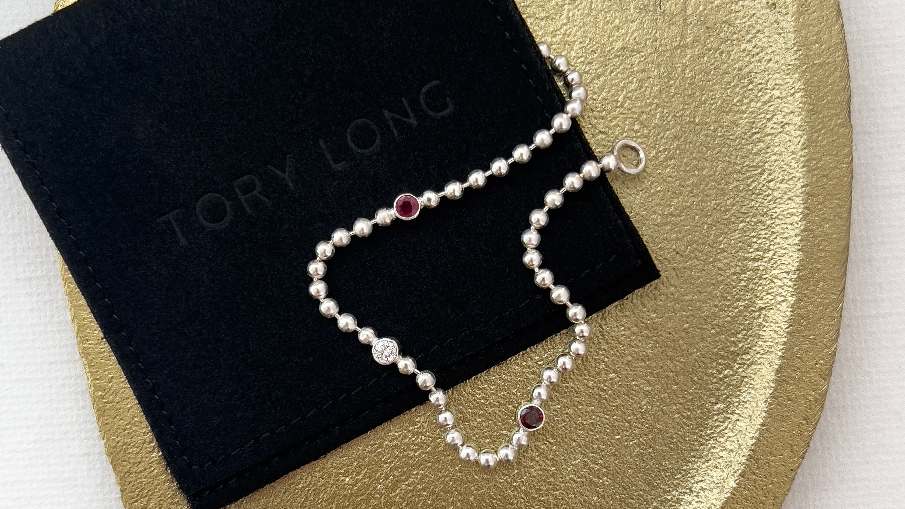 Silver ball chain bracelet with ruby, diamond and garnet on a gold plate