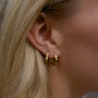 Model wearing stack of 18k Gold vermeil hoops set with black and white 3mm sapphires