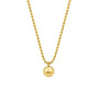 Gold beaded necklace with a large gold pendant on a white background