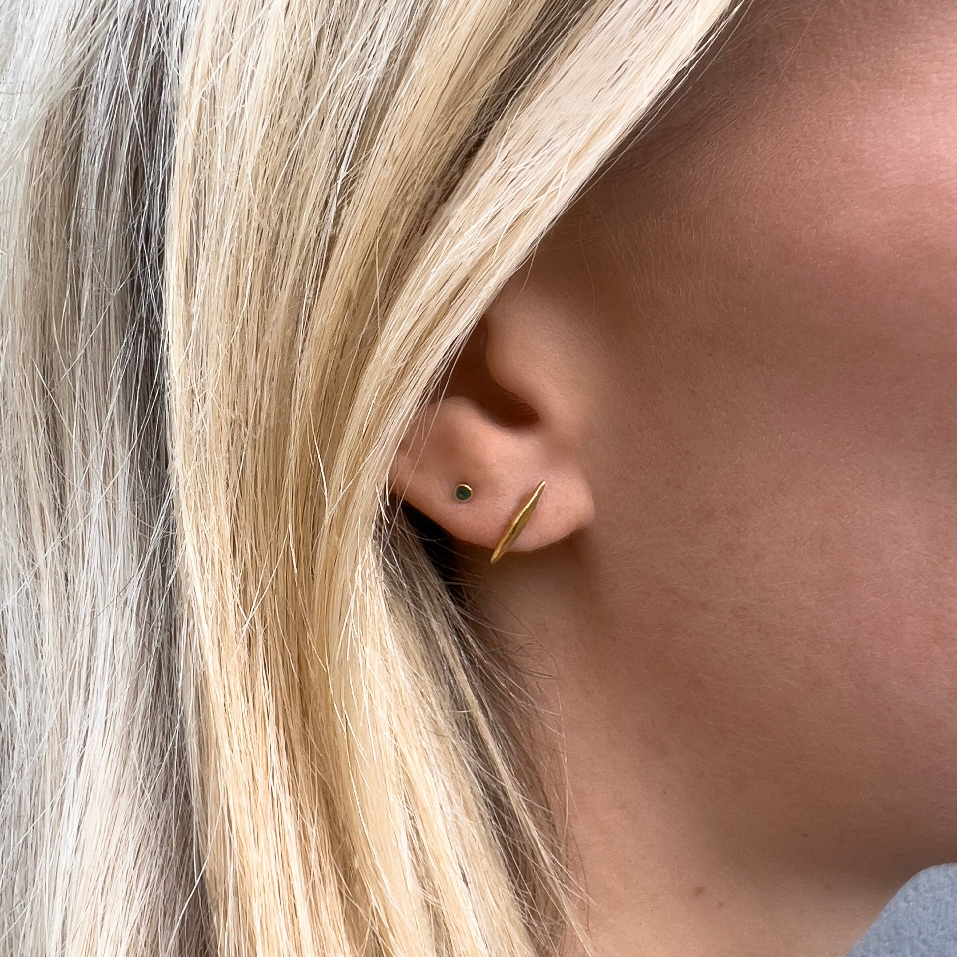 18k gold vermeil spike stud with micro green stud on model