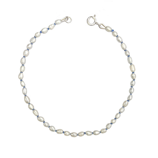 Tiny freshwater pearl bracelet on blue knotted silk cord